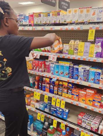 woman in black shirt stocks shelves